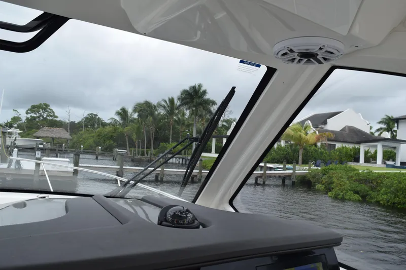 Slide: The Image of Interior detail of 2022 Pursuit OS 355 Offshore boat, featuring sleek seating and oval window. - 240