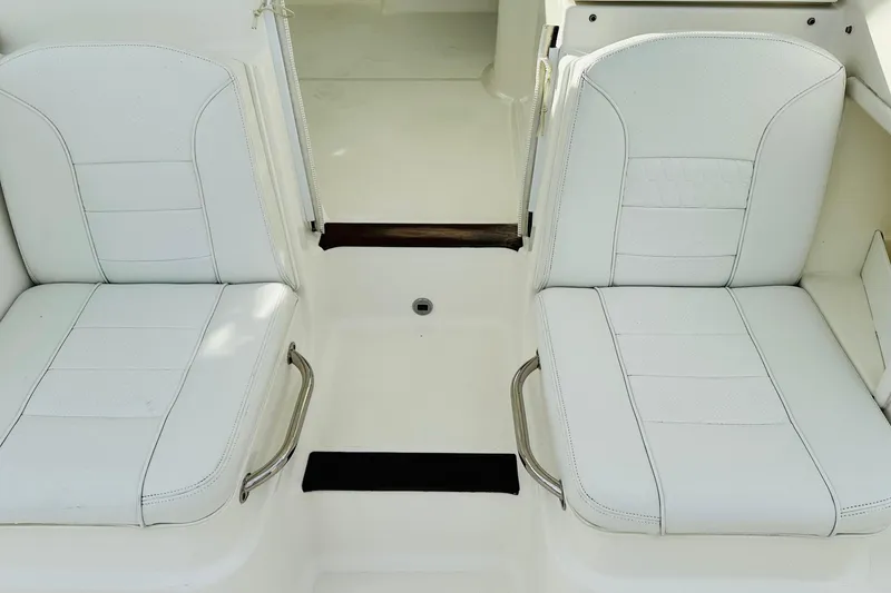 Slide: The Image of 2022 Pursuit OS 355 Offshore boat seating area with cup holders and storage. - 26