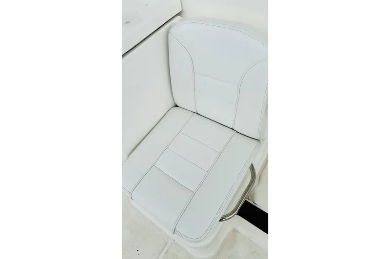 Slide: The Image of 2022 Pursuit OS 355 Offshore boat interior storage compartment with white cushioned seating. - 27