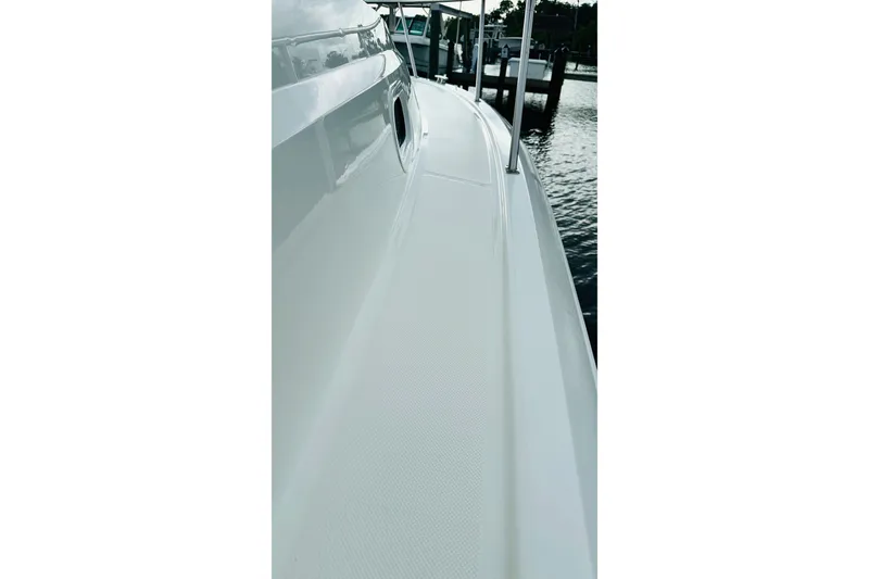 Slide: The Image of 2022 Pursuit OS 355 Offshore boat with white cushioned seating. - 28