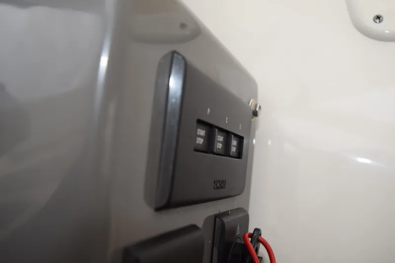 Slide: The Image of 2022 Pursuit OS 355 Offshore boat dashboard with navigation screens and steering wheel. - 303