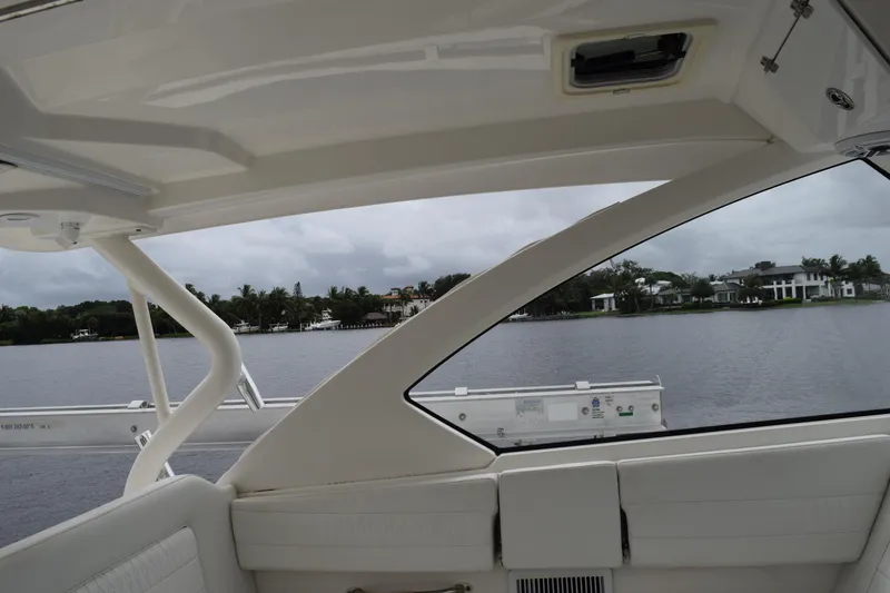 Slide: The Image of 2022 Pursuit OS 355 Offshore boat interior with open door, dockside view. - 338