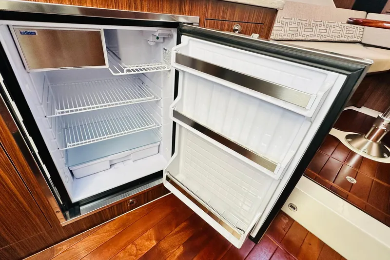 Slide: The Image of 2022 Pursuit OS 355 Offshore boat seat with cup holder detail. - 34