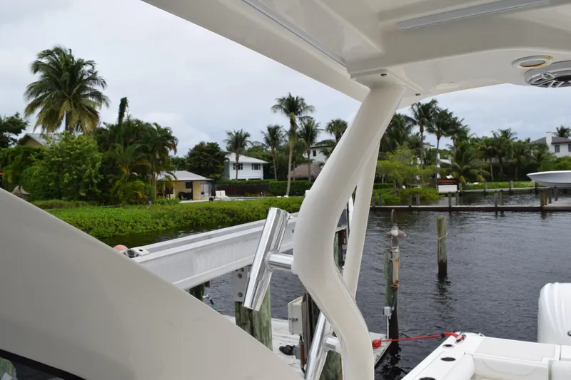 Slide: The Image of 2022 Pursuit OS 355 Offshore boat interior view with open hatch and seating. - 342