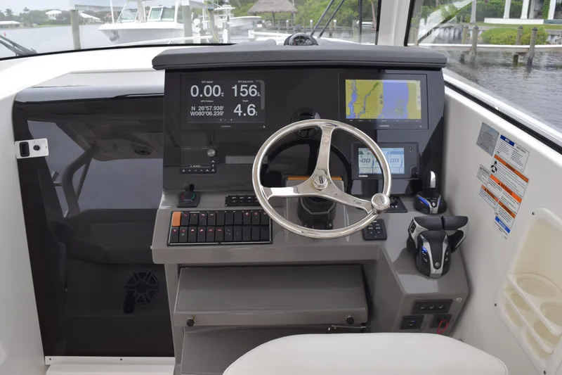 Slide: The Image of 2022 Pursuit OS 355 Offshore boat interior view with seating and speaker. - 343