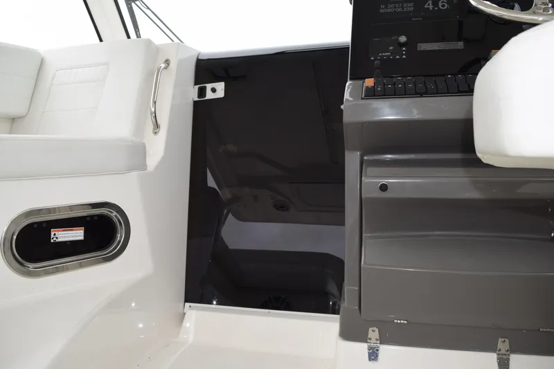 Slide: The Image of Interior view of 2022 Pursuit OS 355 Offshore boat with wooden steps and window. - 346