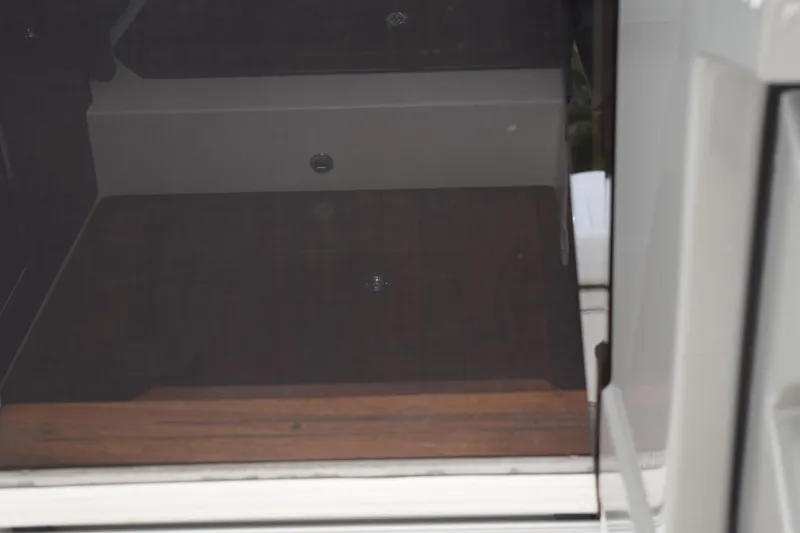 Slide: The Image of Interior view of 2022 Pursuit OS 355 Offshore boat cabin with open door. - 352