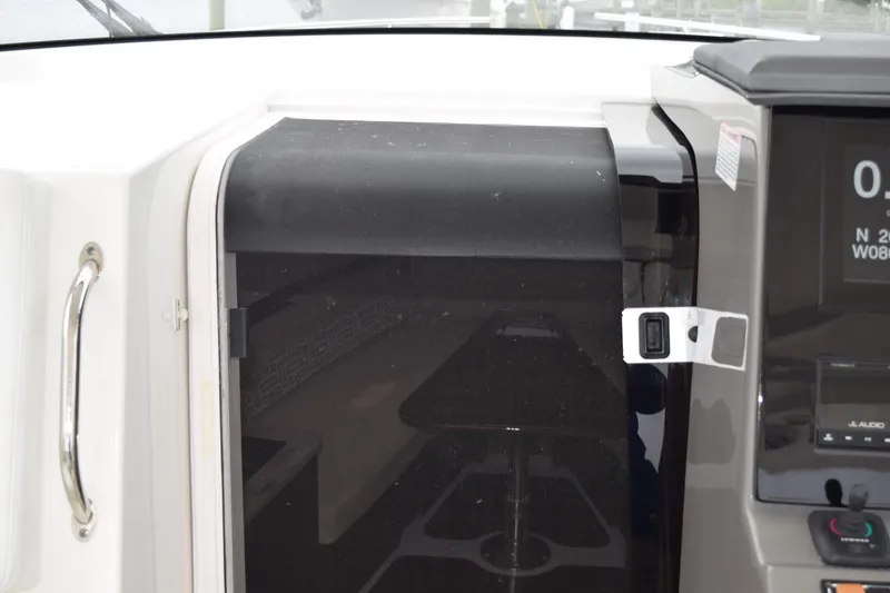 Slide: The Image of 2022 Pursuit OS 355 Offshore boat interior with seating and open cabin door. - 354