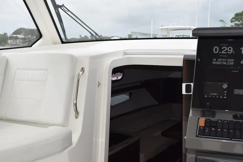 Slide: The Image of Interior view of 2022 Pursuit OS 355 Offshore boat, showcasing cabin entrance and deck area. - 355