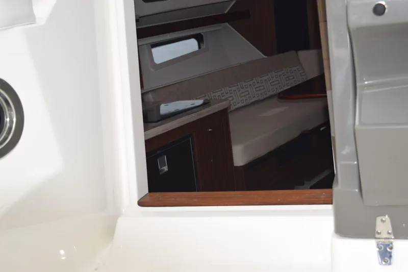 Slide: The Image of Interior view of 2022 Pursuit OS 355 Offshore boat, showing cabin entrance and outdoor seating. - 359