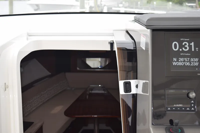 Slide: The Image of Interior view of 2022 Pursuit OS 355 Offshore boat, showing cabin entrance and deck. - 360