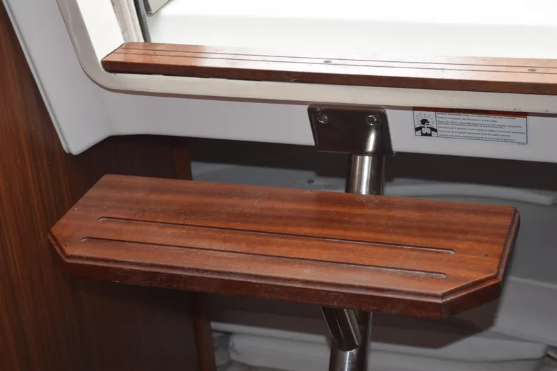 Slide: The Image of Interior of 2022 Pursuit OS 355 Offshore boat with wood paneling and control switches. - 368