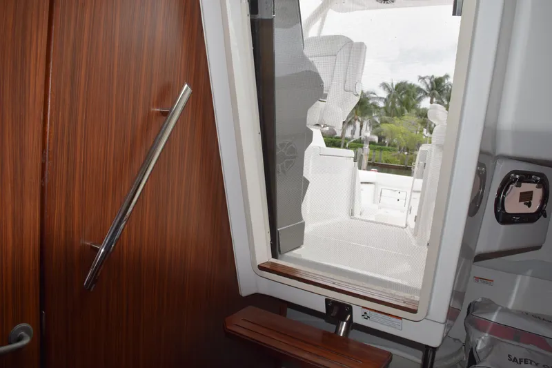 Slide: The Image of 2022 Pursuit OS 355 Offshore bathroom with glass sink and wooden cabinet. - 380