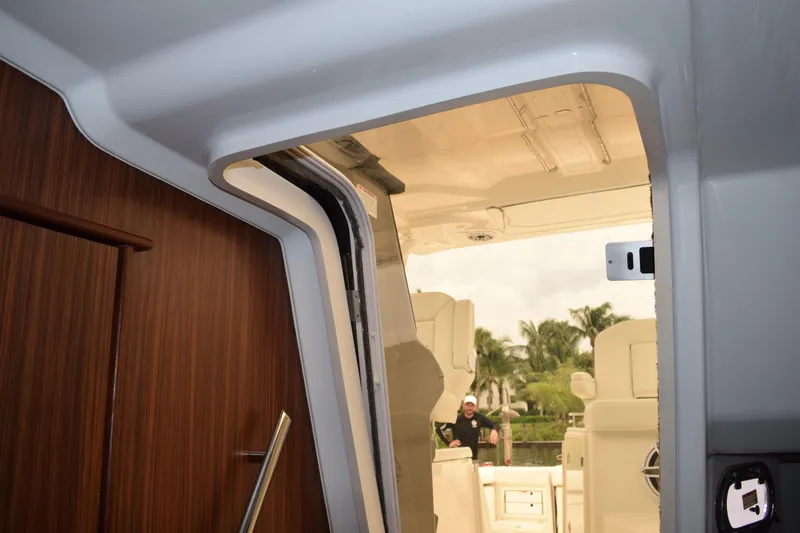 Slide: The Image of Interior cabin of 2022 Pursuit OS 355 Offshore with safety gear bags and wooden cabinetry. - 382