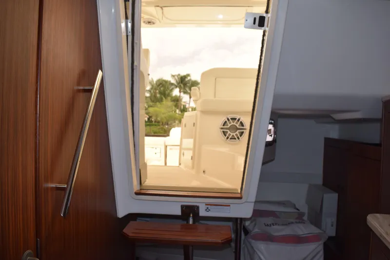 Slide: The Image of 2022 Pursuit OS 355 Offshore cabin interior with wooden cabinetry and storage. - 383