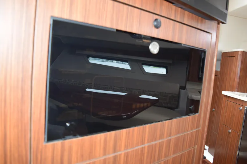 Slide: The Image of Interior of 2022 Pursuit OS 355 Offshore yacht with wood finish and modern design. - 408