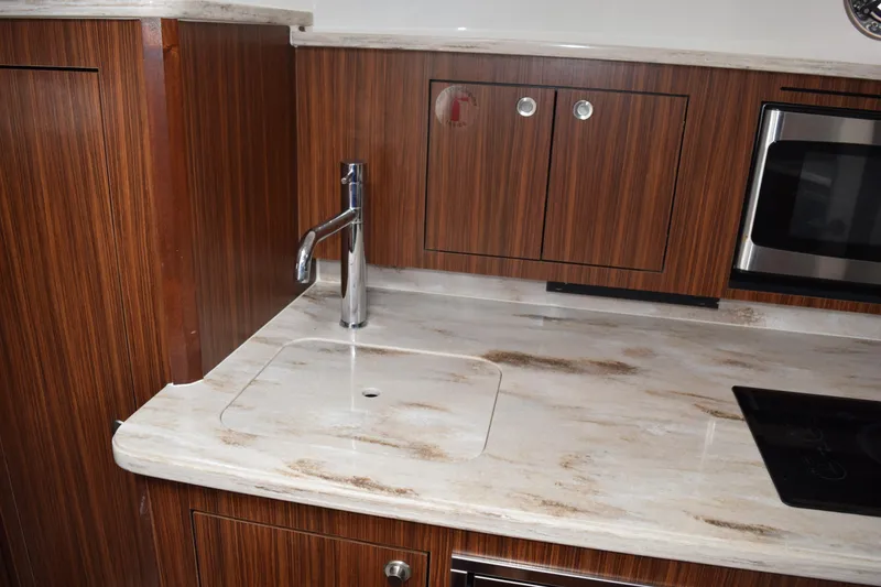 Slide: The Image of 2022 Pursuit OS 355 Offshore cabin interior with seating and table. - 416