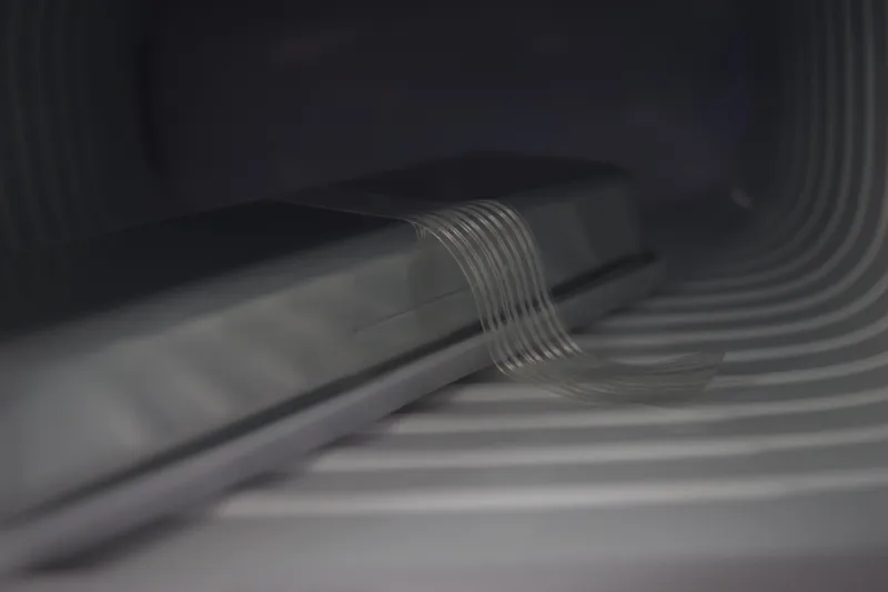 Slide: The Image of 2022 Pursuit OS 355 Offshore boat on a lift, side view under cloudy sky. - 455