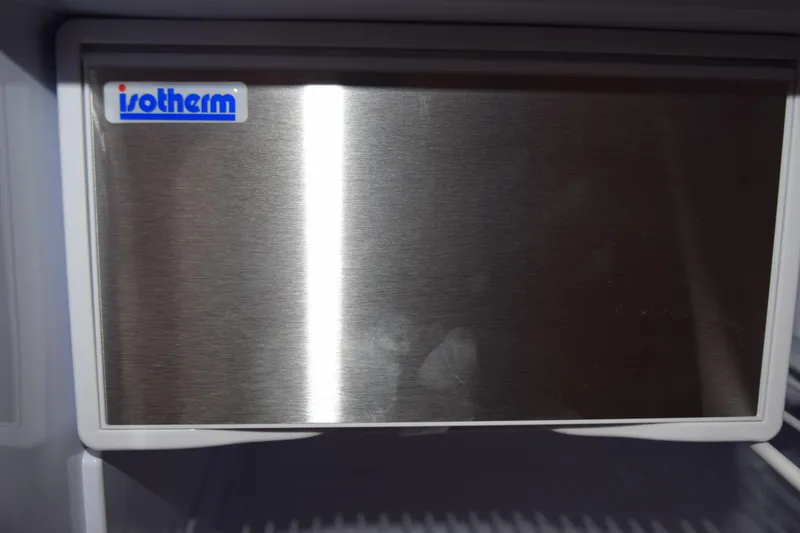 Slide: The Image of 2022 Pursuit OS 355 Offshore boat with Yamaha engine docked by waterfront homes. - 456