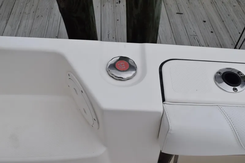 Slide: The Image of 2022 Pursuit OS 355 Offshore boat with open storage compartment and twin outboard engines. - 56