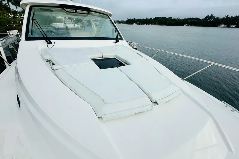 Slide: The Image of 2022 Pursuit OS 355 Offshore yacht kitchen with wood cabinetry and modern appliances. - 6