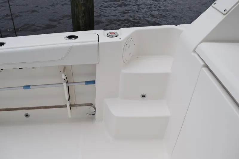 Slide: The Image of 2022 Pursuit OS 355 Offshore boat interior, featuring "American Made" branding and storage compartments. - 74