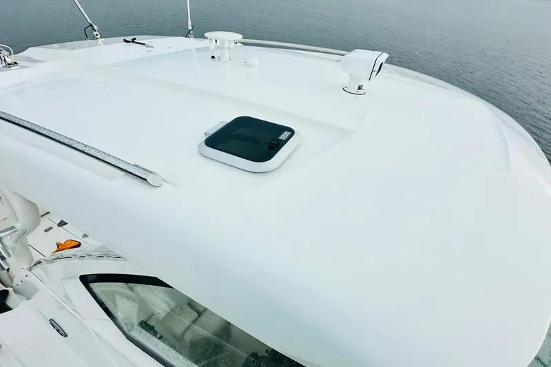 Slide: The Image of 2022 Pursuit OS 355 Offshore cabin with elegant seating and wooden table. - 8