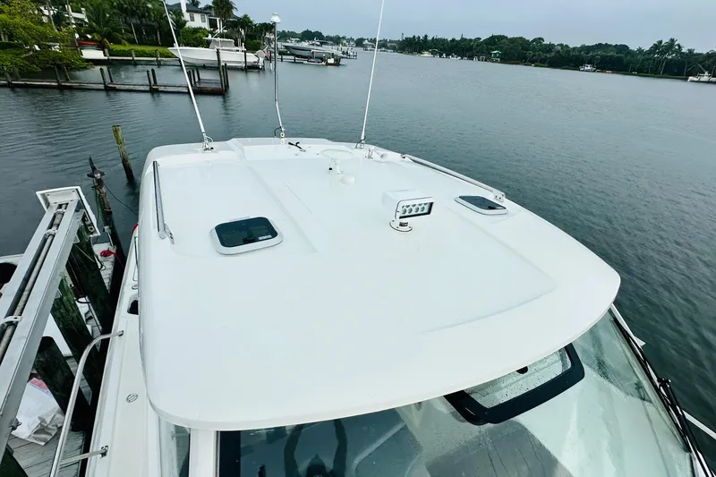 Slide: The Image of Interior of 2022 Pursuit OS 355 Offshore boat with TV and seating area. - 9