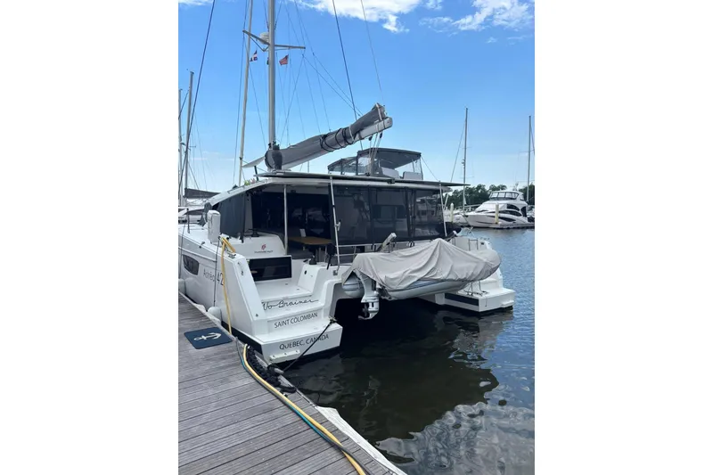Slide: The Image of 2022 Fountaine Pajot Astrea 42 catamaran docked at marina, rear view. - 15