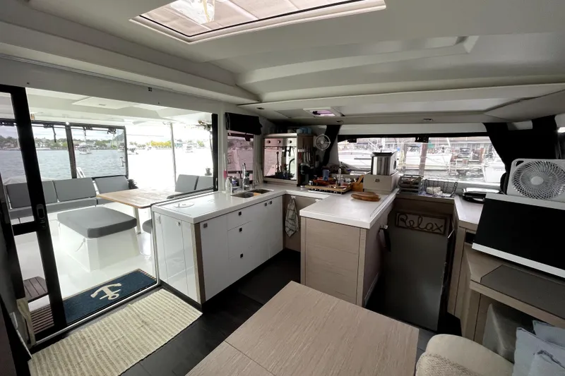 Slide: The Image of Modern interior of 2022 Fountaine Pajot Astrea 42 catamaran with spacious kitchen and seating area. - 3