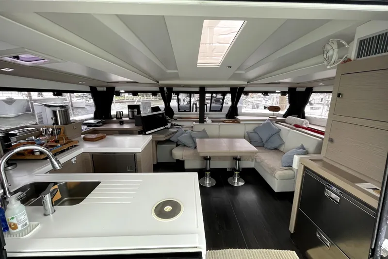 Slide: The Image of Luxurious interior of 2022 Fountaine Pajot Astrea 42 catamaran with modern kitchen and seating area. - 4