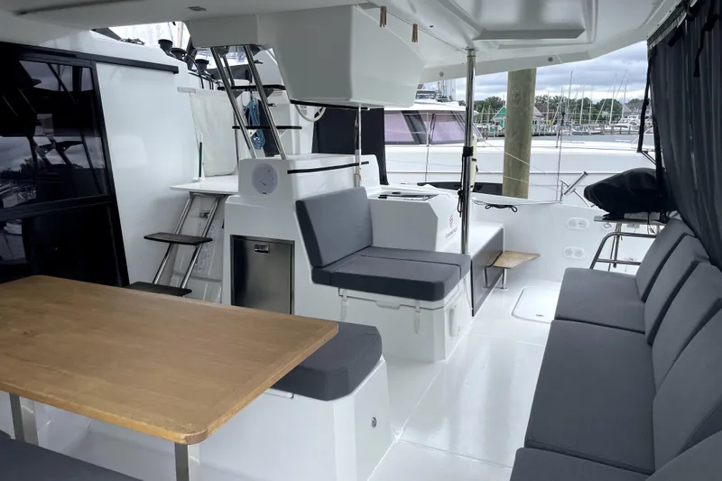 Slide: The Image of 2022 Fountaine Pajot Astrea 42 yacht interior with seating and dining area. - 7