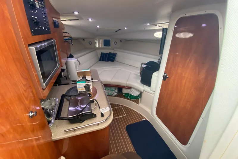 Slide: The Image of Interior of 2014 Wellcraft 340 Coastal boat with kitchenette and seating area. - 17
