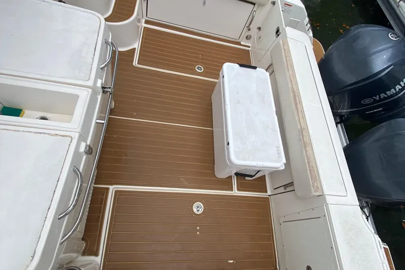 Slide: The Image of 2014 Wellcraft 340 Coastal boat deck with Yamaha engines and storage compartments. - 22
