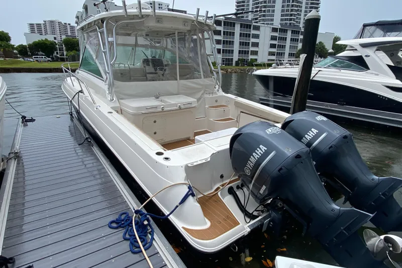 Slide: The Image of 2014 Wellcraft 340 Coastal boat docked with twin Yamaha engines. - 28