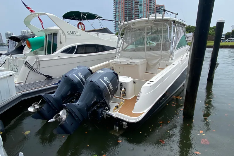 Slide: The Image of 2014 Wellcraft 340 Coastal boat docked with twin Yamaha outboard engines. - 30