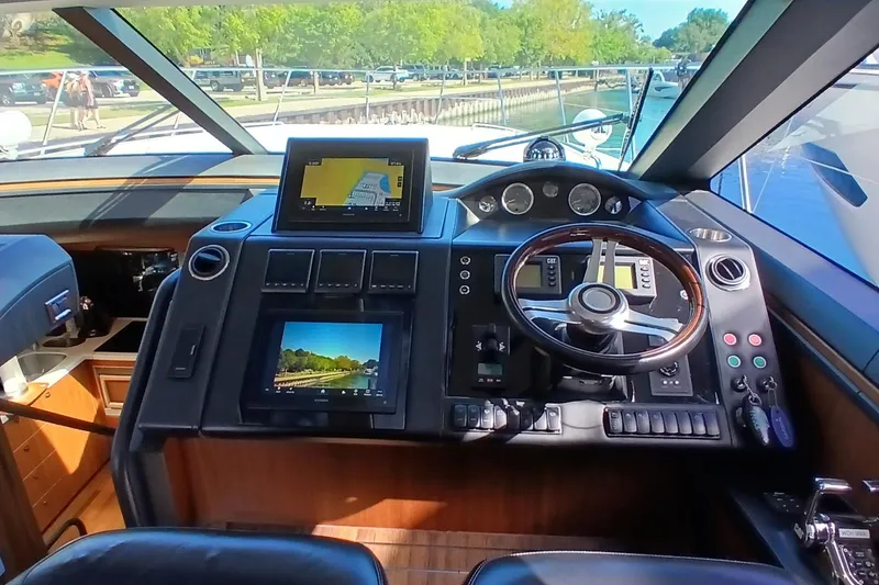 Slide: The Image of Cockpit of 2015 Princess V62-S yacht with navigation screens and steering wheel. - 12