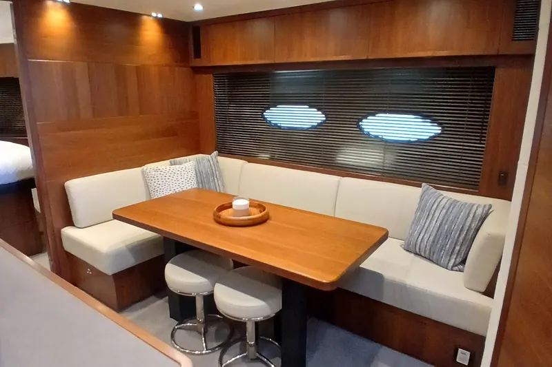 Slide: The Image of Luxurious 2015 Princess V62-S yacht interior with elegant dining area and plush seating. - 15