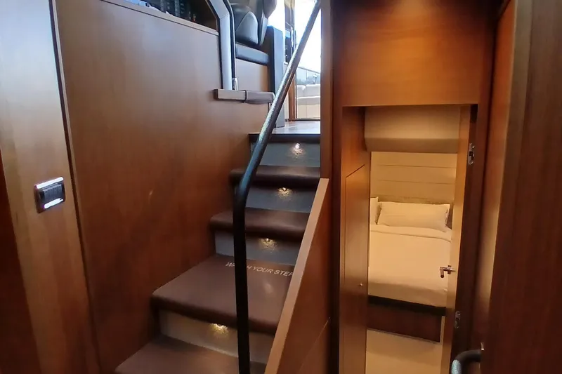 Slide: The Image of Interior of 2015 Princess V62-S yacht with wooden stairs and cozy bedroom. - 16