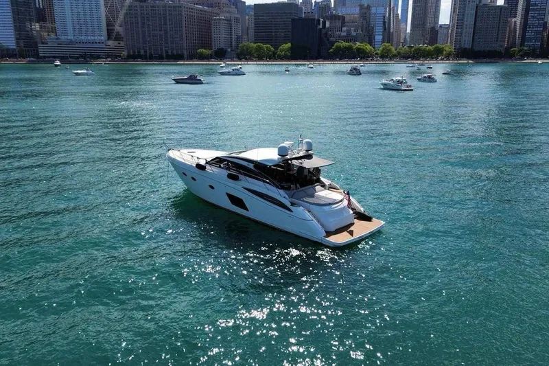 Slide: The Image of Luxurious 2015 Princess V62-S yacht cruising on a sunny day near a city skyline. - 2