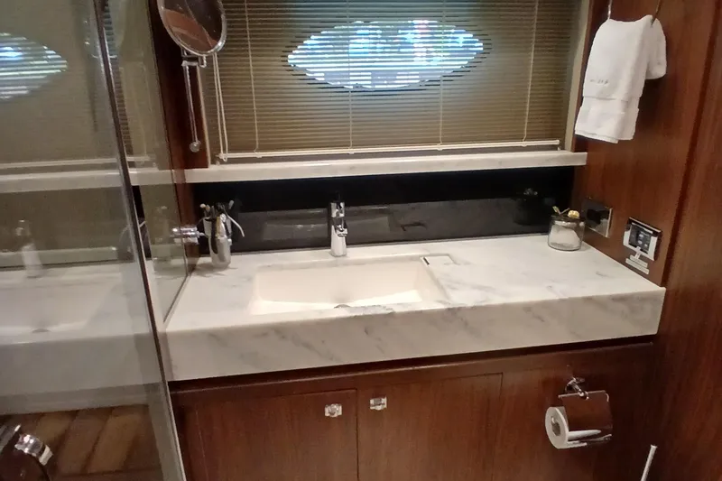 Slide: The Image of Luxurious bathroom in 2015 Princess V62-S yacht with marble countertop and modern fixtures. - 21