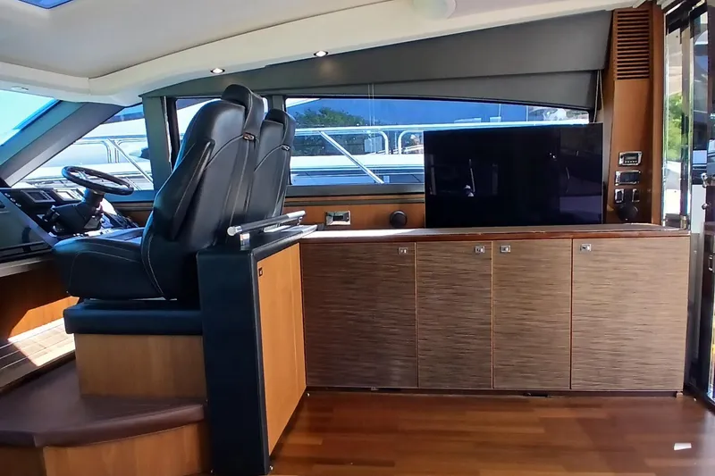 Slide: The Image of Luxurious interior of 2015 Princess V62-S yacht with marina view through glass doors. - 9