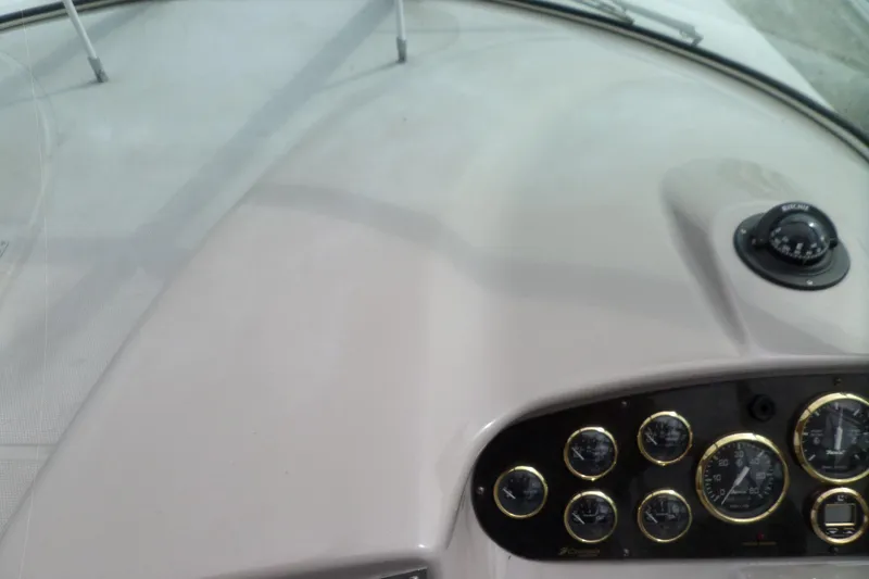 Slide: The Image of Dashboard of 2003 Cruisers Yachts 3275 Express with gauges and compass. - 27