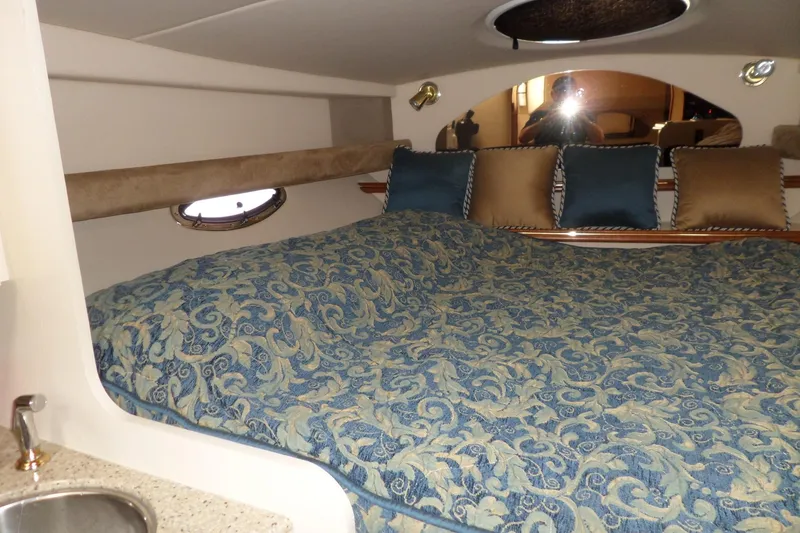 Slide: The Image of 2003 Cruisers Yachts 3275 Express cabin with patterned bedding and decorative pillows. - 35