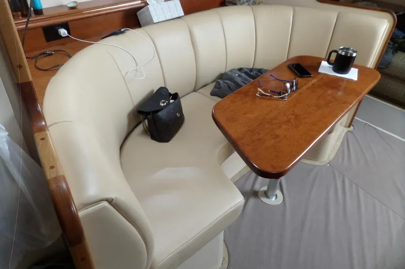 Slide: The Image of Interior of 2003 Cruisers Yachts 3275 Express with beige seating and wooden table. - 41