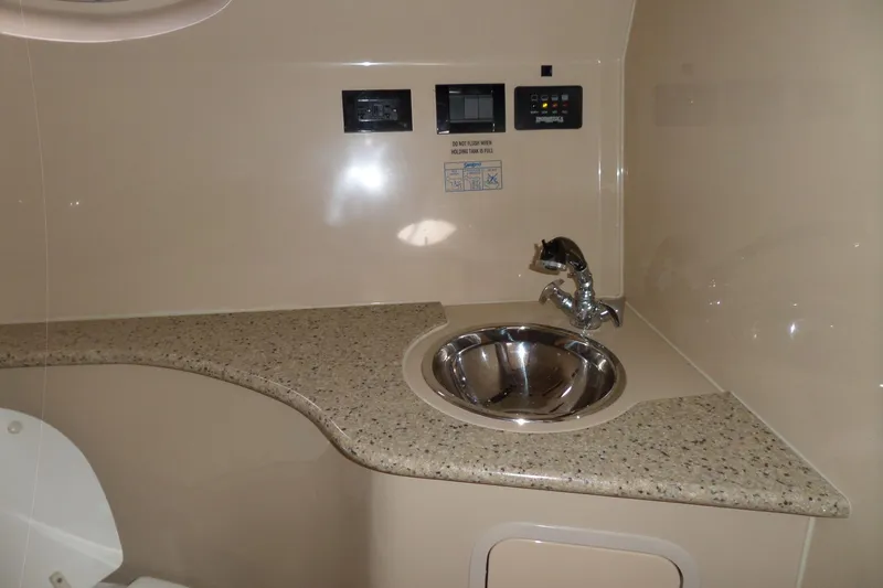 Slide: The Image of 2003 Cruisers Yachts 3275 Express bathroom sink with granite countertop and modern fixtures. - 45