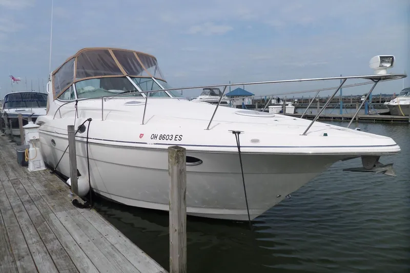The Image of 2003 Cruisers Yachts 3275 Express docked at marina, side view. - 0