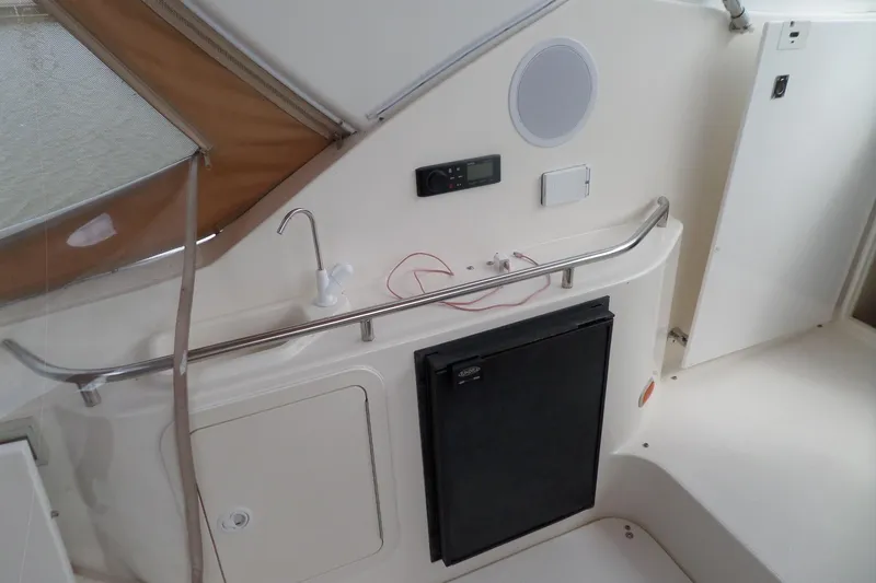Slide: The Image of 2003 Cruisers Yachts 3275 Express interior with sink and mini fridge. - 10