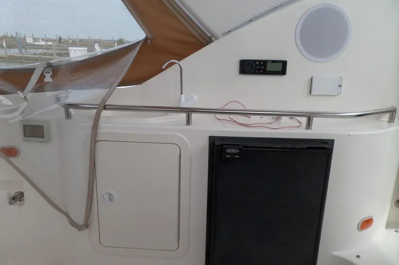 Slide: The Image of 2003 Cruisers Yachts 3275 Express interior with fridge, sink, and control panel. - 12