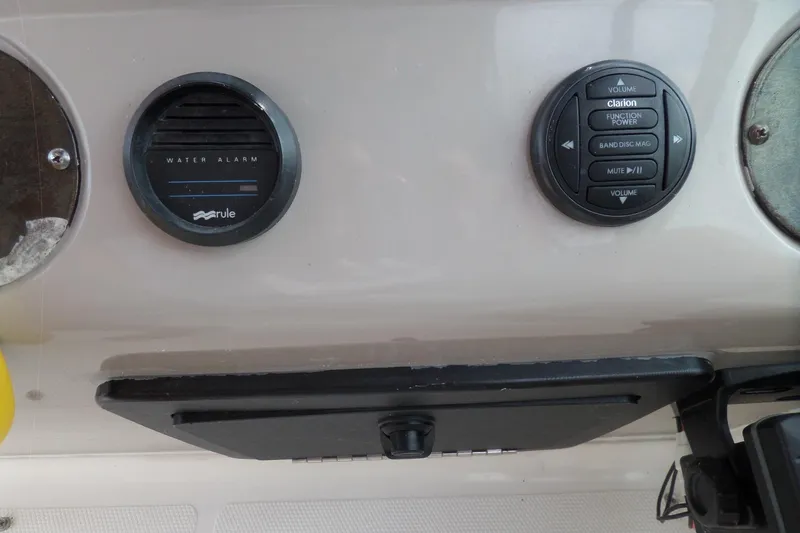 Slide: The Image of 2003 Cruisers Yachts 3275 Express dashboard with water alarm and audio controls. - 22